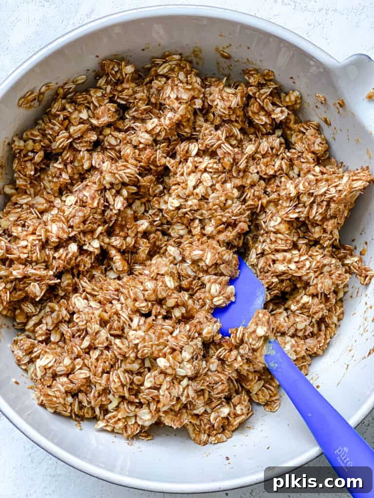 Simple Peanut Butter Granola Clusters 9 process shot of mixing ingredients together in a bowl