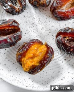 Spiced Pumpkin Date Delights 14 A close-up view of a sliced date already stuffed with the pumpkin mixture, showcasing the ready-to-dip treat.