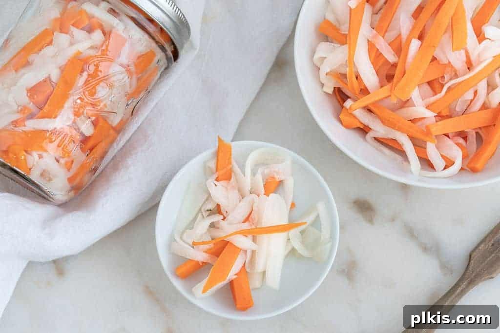Orange Gold: The Ultimate Carrot Compendium 4 finished pickled carrots in a jar and in two separate bowls against a white background