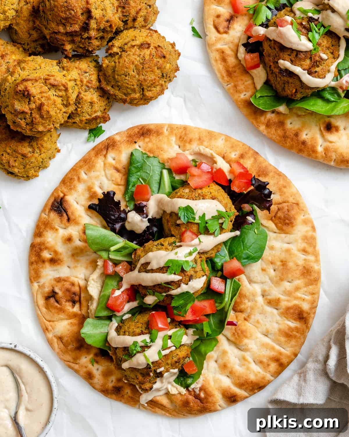 Crispy Healthy Falafel Baked or Air Fried 2 completed Healthy Baked Falafel on bread against a white background