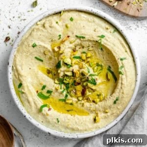 Completed Pistachio Hummus in a bowl, garnished with pistachios and parsley.