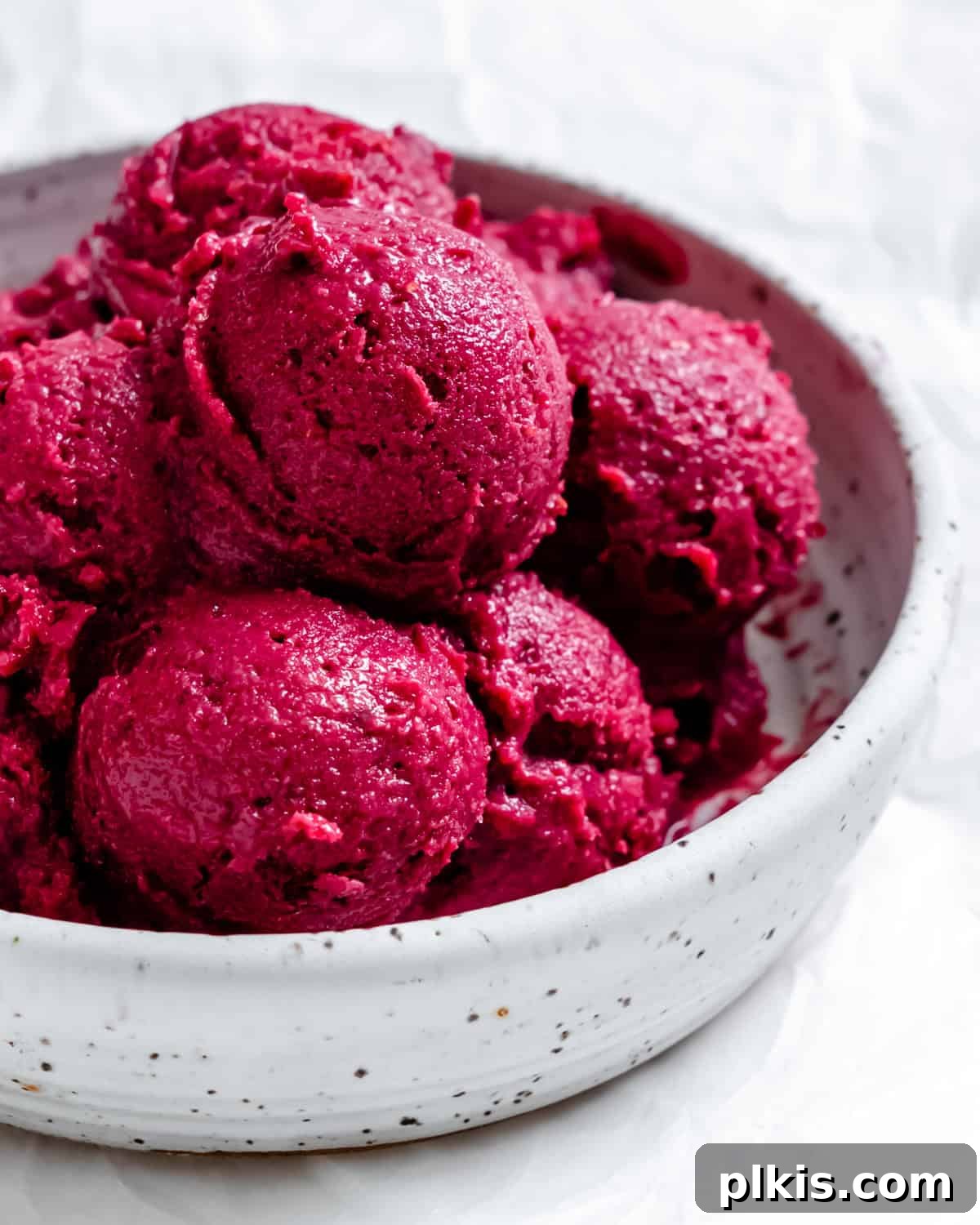 Instant Berry Tofu Nice Cream 2 A vibrant bowl of completed 5-Minute Berry Tofu Ice Cream, garnished with fresh berries.