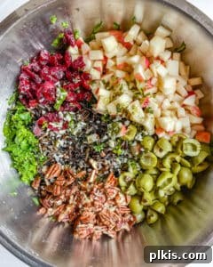 Process of mixing wet and dry ingredients for the salad in a stainless steel bowl