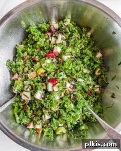 Golden Harvest Wild Rice Salad 7 Final stage of mixing all salad ingredients together in a stainless steel bowl, showing the vibrant colors