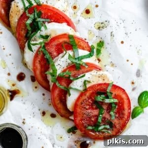 Plant-Based Caprese Delight 7 completed Vegan Caprese Salad on a white surface, garnished with basil