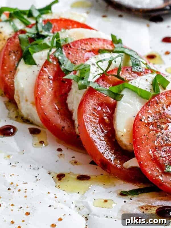 Plant-Based Caprese Delight 6 Completed Vegan Caprese Salad artfully arranged on a white serving platter, ready to enjoy.