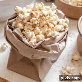 20 Delicious Vegan Autumn Desserts 7 Completed Chai Popcorn in a bowl against a white surface.