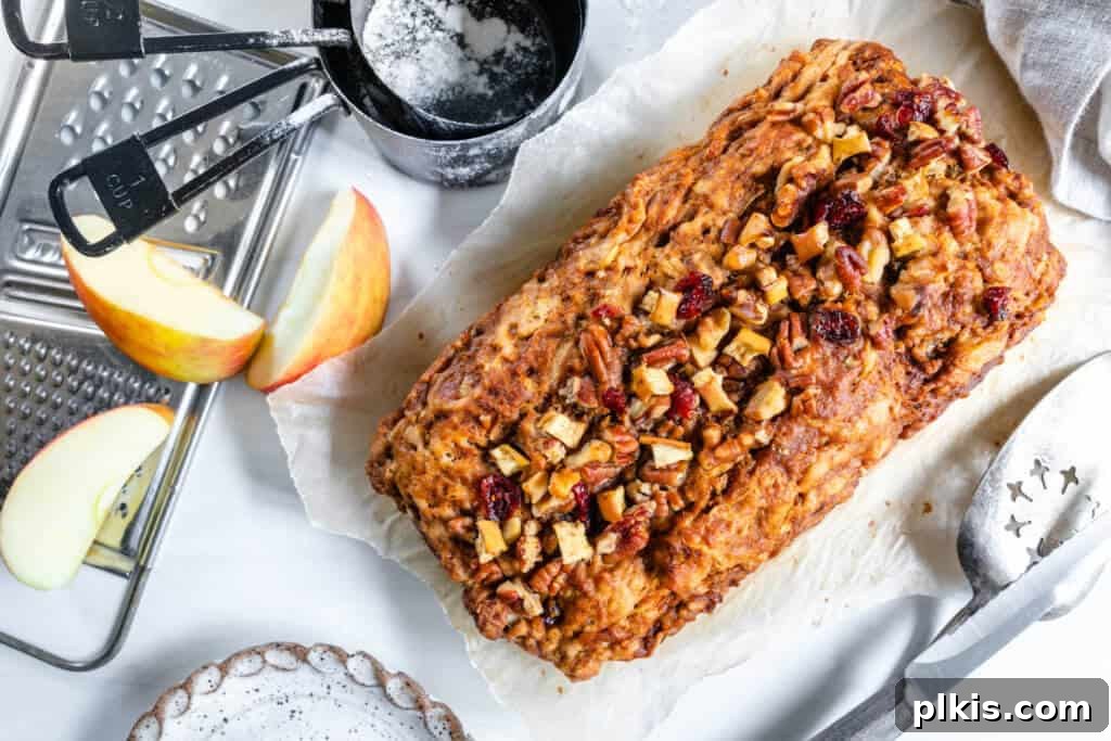 20 Delicious Vegan Autumn Desserts 8 Vegan Apple Cinnamon bread on a white surface with ingredients in the background