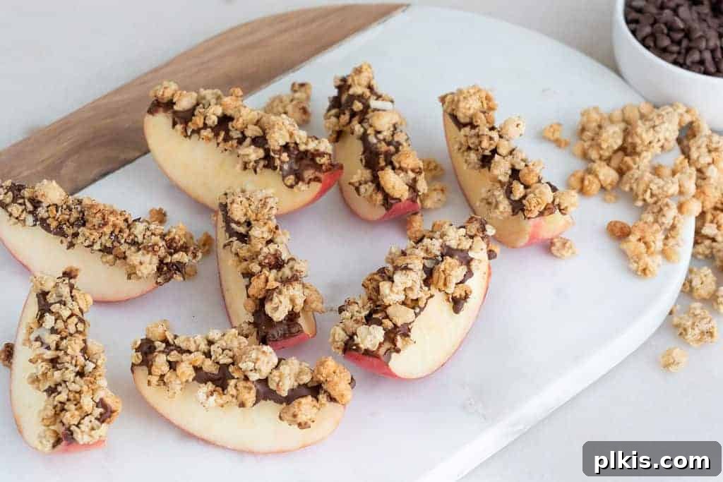 20 Delicious Vegan Autumn Desserts 15 several apples with granola and chocolate on top on a white cutting board