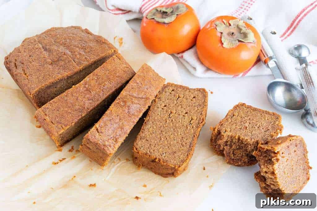 20 Delicious Vegan Autumn Desserts 3 persimmon bread slices on a white surface with persimmons in the background