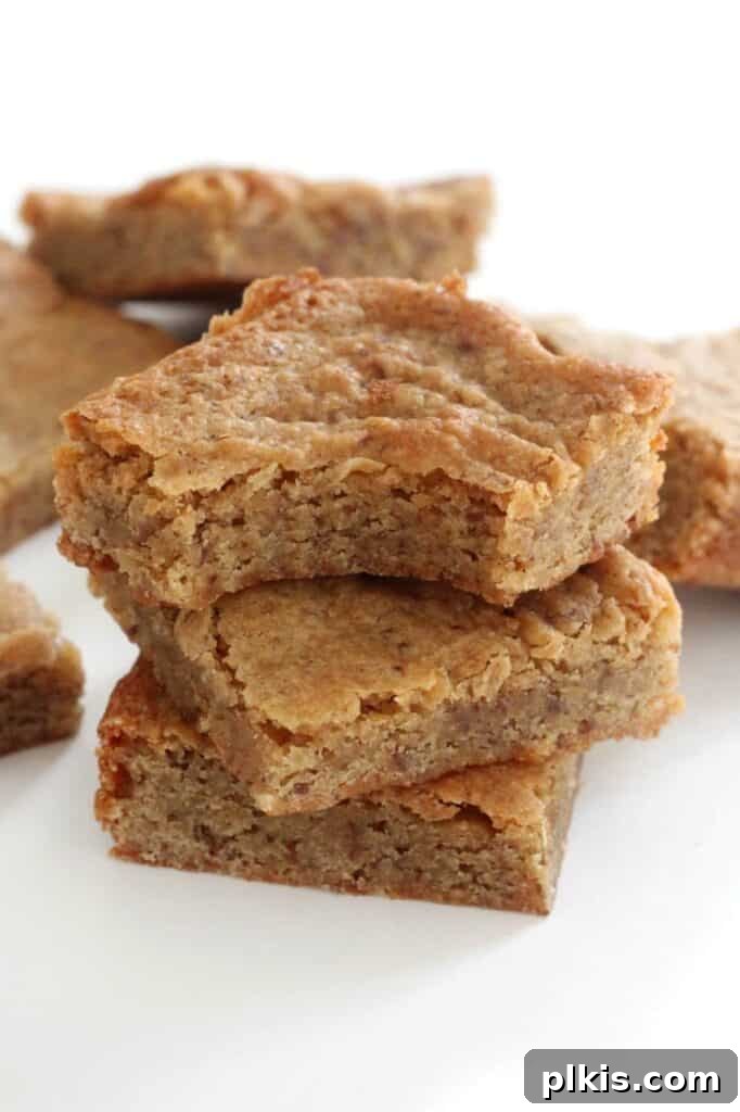 20 Delicious Vegan Autumn Desserts 18 finished gluten free maple blondies stacked on each other against a white background