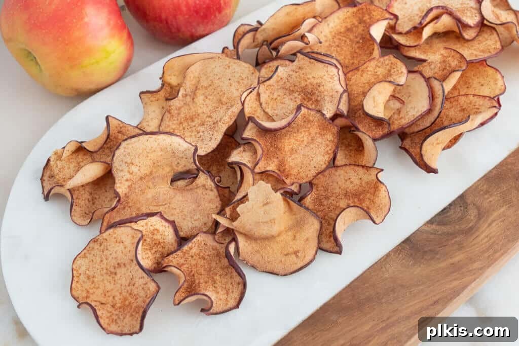 20 Delicious Vegan Autumn Desserts 5 finished apple chips spread out on a white tray
