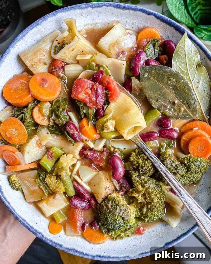 Hearty Vegan Minestrone 2 A steaming bowl of Vegan Minestrone Soup, garnished with fresh herbs, ready to be enjoyed.