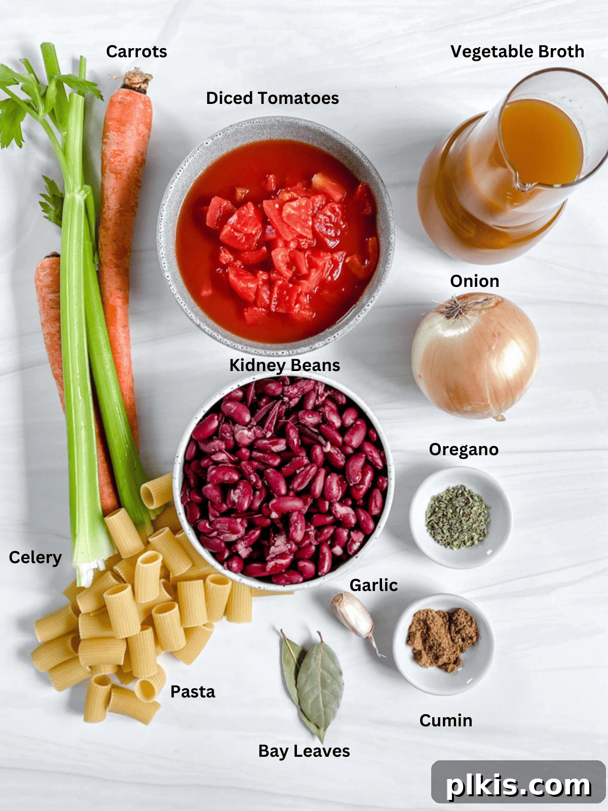 Hearty Vegan Minestrone 3 A curated display of fresh vegetables, canned goods, and pantry staples laid out for making Minestrone Soup.