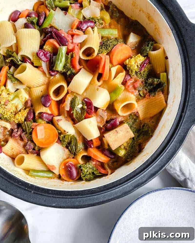 Hearty Vegan Minestrone 8 A large pot filled with freshly cooked Vegan Minestrone Soup, ready to be served, capturing its vibrant colors and inviting steam.
