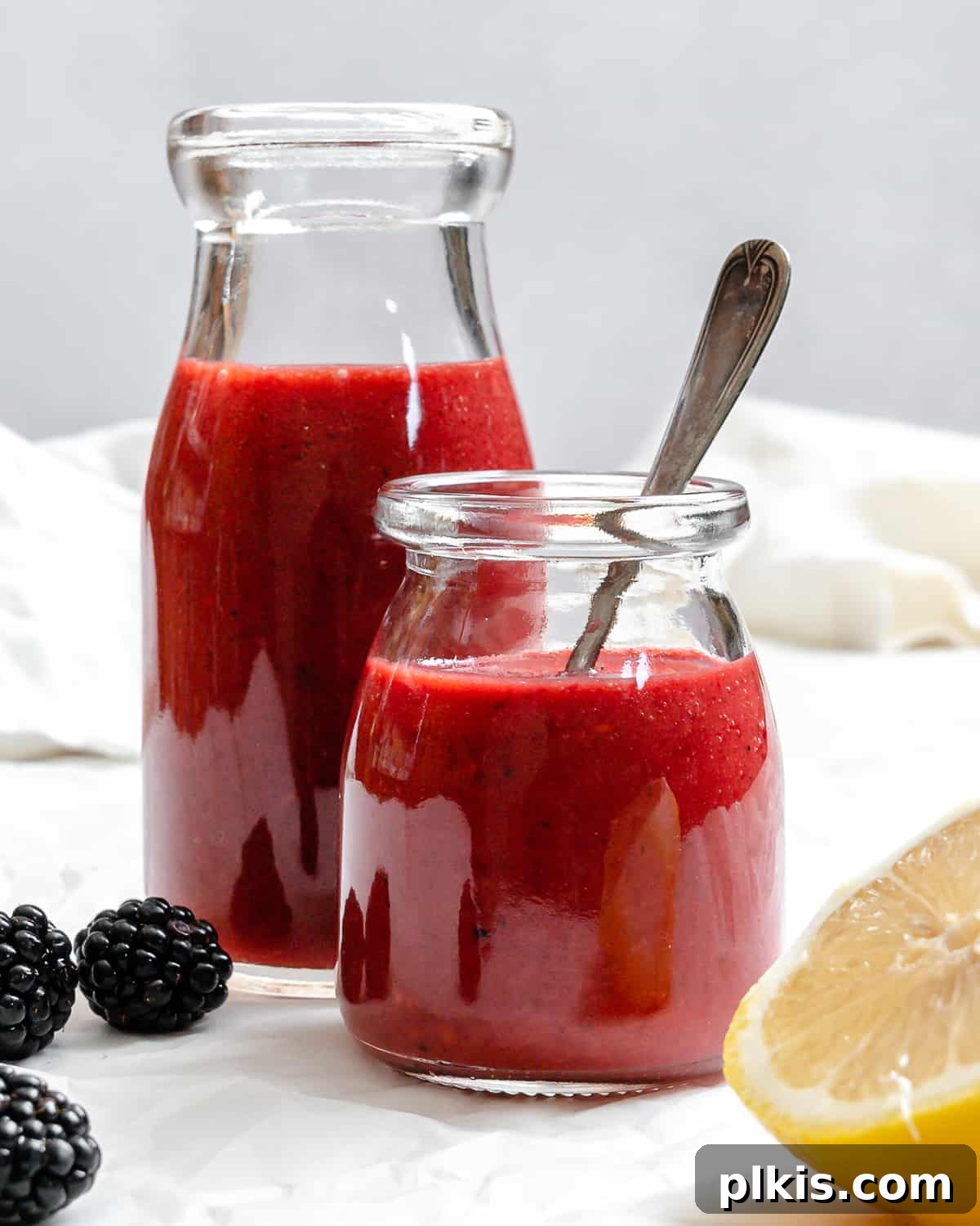 Effortless Blackberry Dressing 2 Completed 5-Minute Blackberry Vinaigrette in two glass jars.