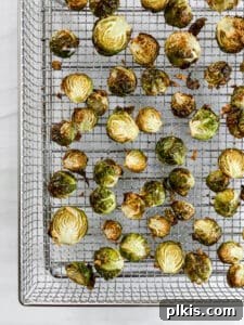 Crispy Air Fryer Brussels Sprouts 12 cooked brussels sprouts spread out on a wire rack