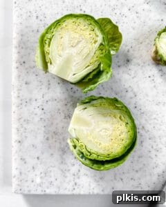 Crispy Air Fryer Brussels Sprouts 5 sliced brussels sprouts on a light cutting board