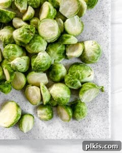 Crispy Air Fryer Brussels Sprouts 6 sliced brussels sprouts on a white cutting board