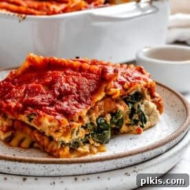 a piece of vegan lasagna on a white plate.