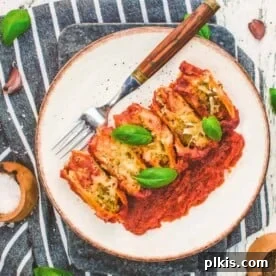 completed vegan stuffed shells plated on a white plate against a gray and white towel