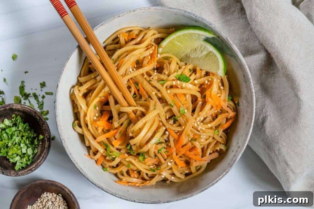 20 Effortless Plant-Based Pasta Dishes for Delicious Dinners 3 finished Sesame Noodle Salad plated in a white dish with chopsticks against a white background