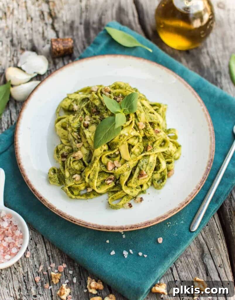 20 Effortless Plant-Based Pasta Dishes for Delicious Dinners 4 finished walnut pesto on a white plate against a blue towel and dark background