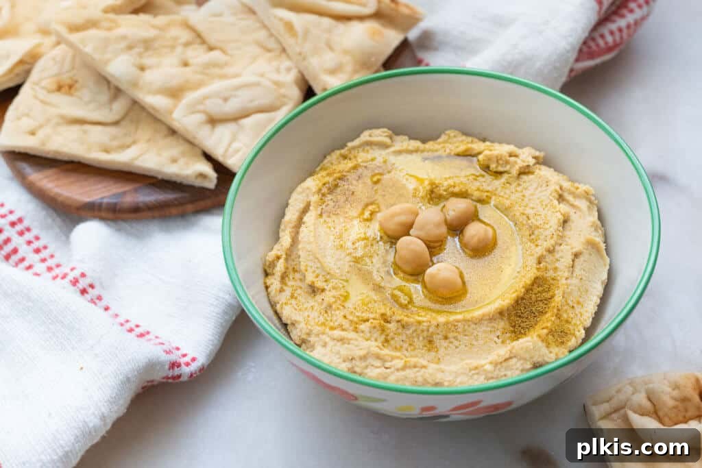 20 Effortless Plant-Based Pasta Dishes for Delicious Dinners 33 finished Classic Hummus in a white bowl with chips in the background