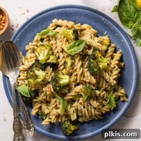 finished Tahini Pasta in a blue plate against a white background