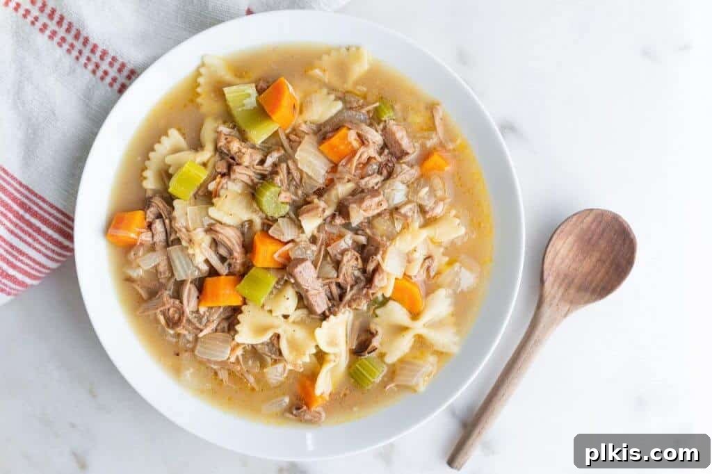 20 Effortless Plant-Based Pasta Dishes for Delicious Dinners 8 finished Jackfruit Chicken Soup in a white bowl against a white background