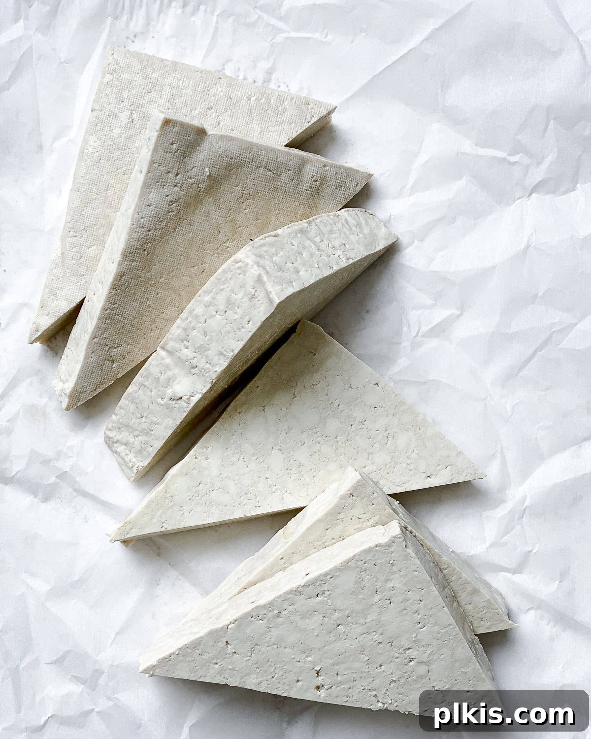 Ultimate Ginger Marinated Tofu 4 Process shot showing sliced tofu on a white surface, ready for marination.