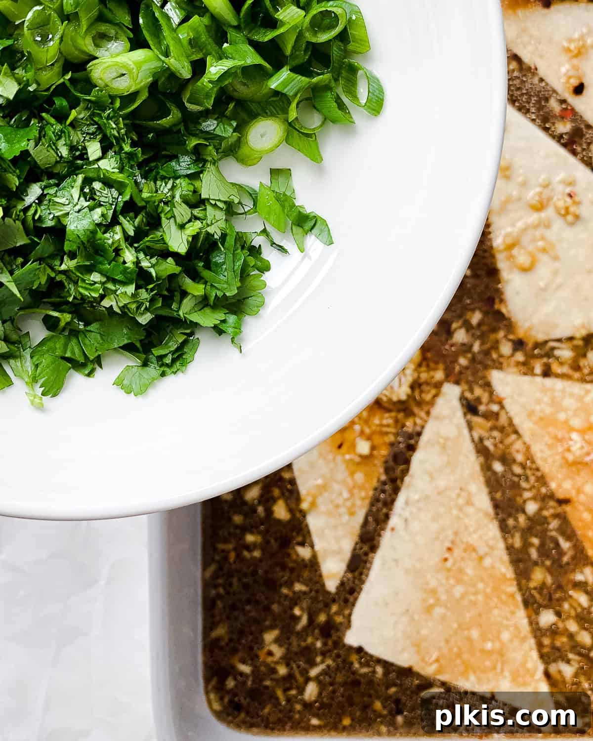 Ultimate Ginger Marinated Tofu 7 Process shot showing green onion and cilantro added on top of marinated tofu.
