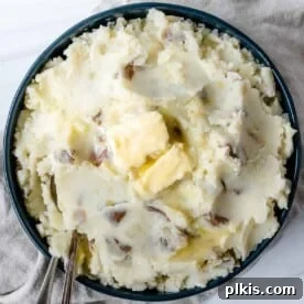45 Mouthwatering Vegan Thanksgiving Recipes 15 Completed vegan mashed potatoes, beautifully plated against a white surface.