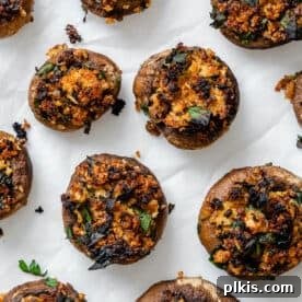 45 Mouthwatering Vegan Thanksgiving Recipes 3 Easy Vegan Stuffed Mushrooms, perfectly baked and displayed on a white surface.