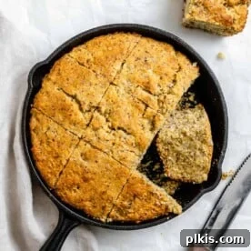 45 Mouthwatering Vegan Thanksgiving Recipes 33 Completed Vegan Cornbread Recipe in a Cast Iron Skillet against a white background.