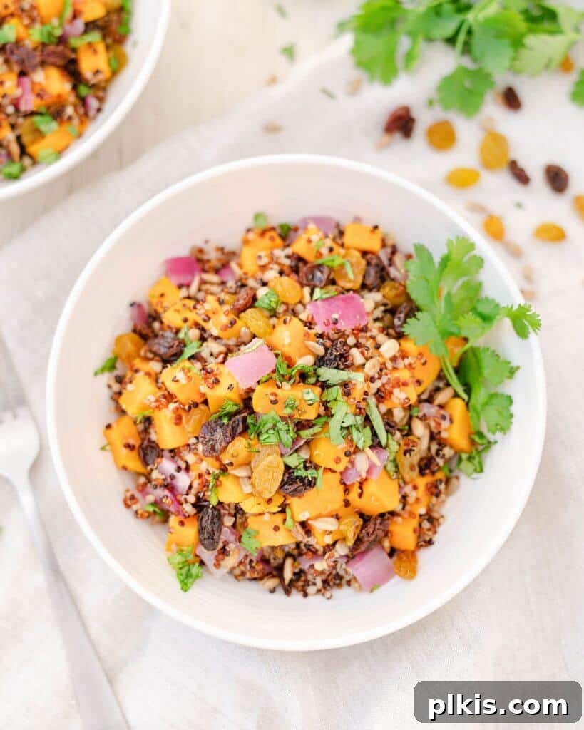 45 Mouthwatering Vegan Thanksgiving Recipes 34 A beautifully arranged sweet potato quinoa salad in a white bowl, with ingredients spread out in the background.