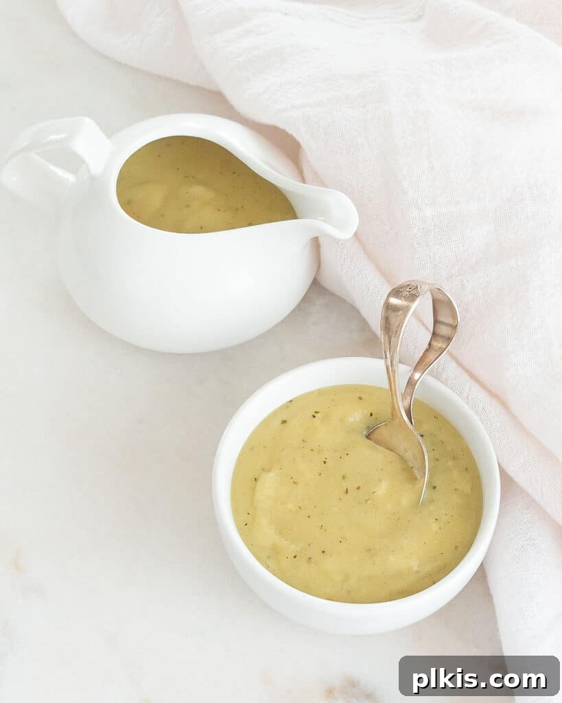 45 Mouthwatering Vegan Thanksgiving Recipes 38 Simple vegan gravy served in an elegant gravy boat against a clean white background.