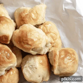 45 Mouthwatering Vegan Thanksgiving Recipes 44 Completed Easy Vegan Dinner Rolls on a white baking dish against a white background.