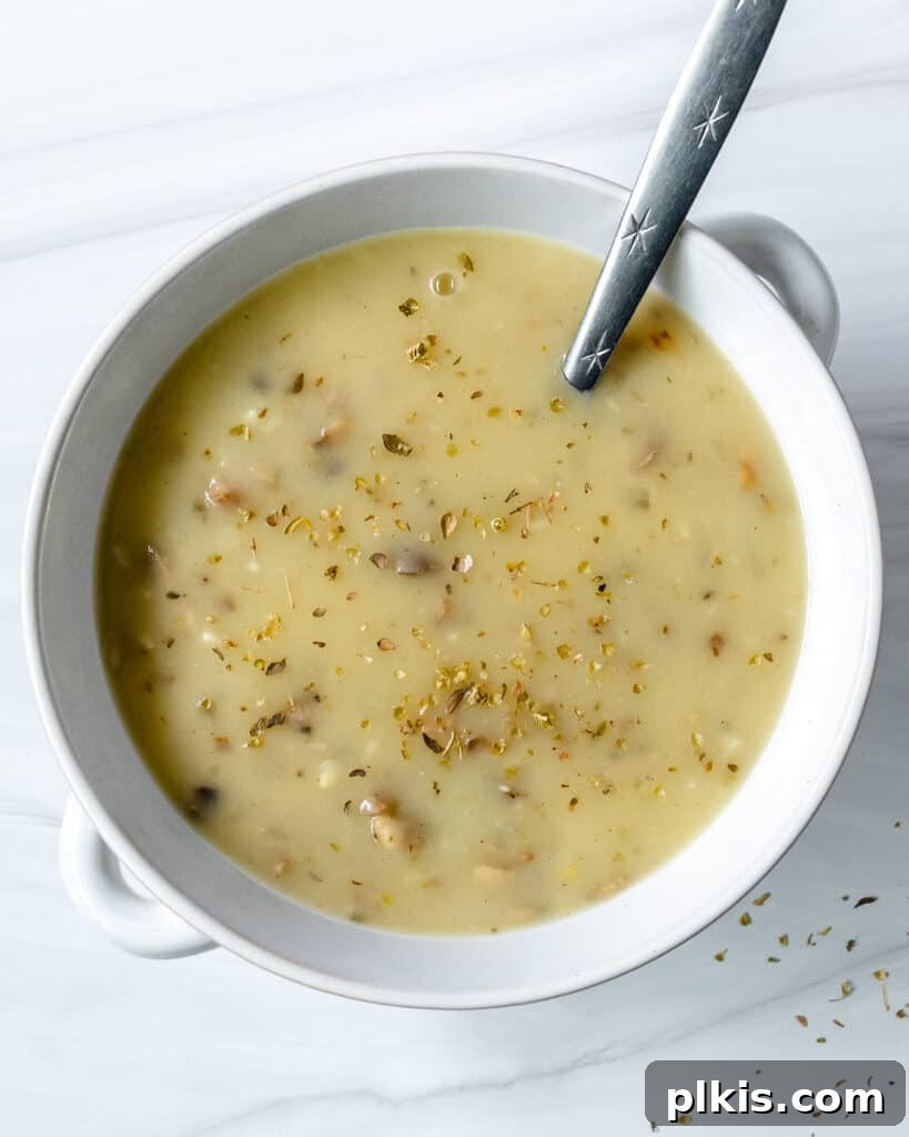 45 Mouthwatering Vegan Thanksgiving Recipes 47 A bowl of completed vegan mushroom gravy, rich and savory, set against a pristine white background.