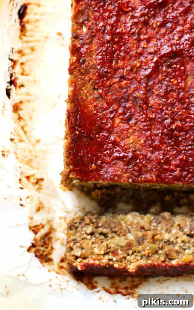 45 Mouthwatering Vegan Thanksgiving Recipes 53 A delicious vegan cauliflower loaf for Thanksgiving, with a slice already cut out and ready to serve.