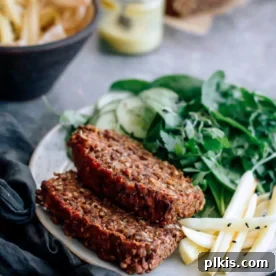 45 Mouthwatering Vegan Thanksgiving Recipes 57 Finished slices of a hearty vegan lentil loaf, served on a bed of fresh greens.