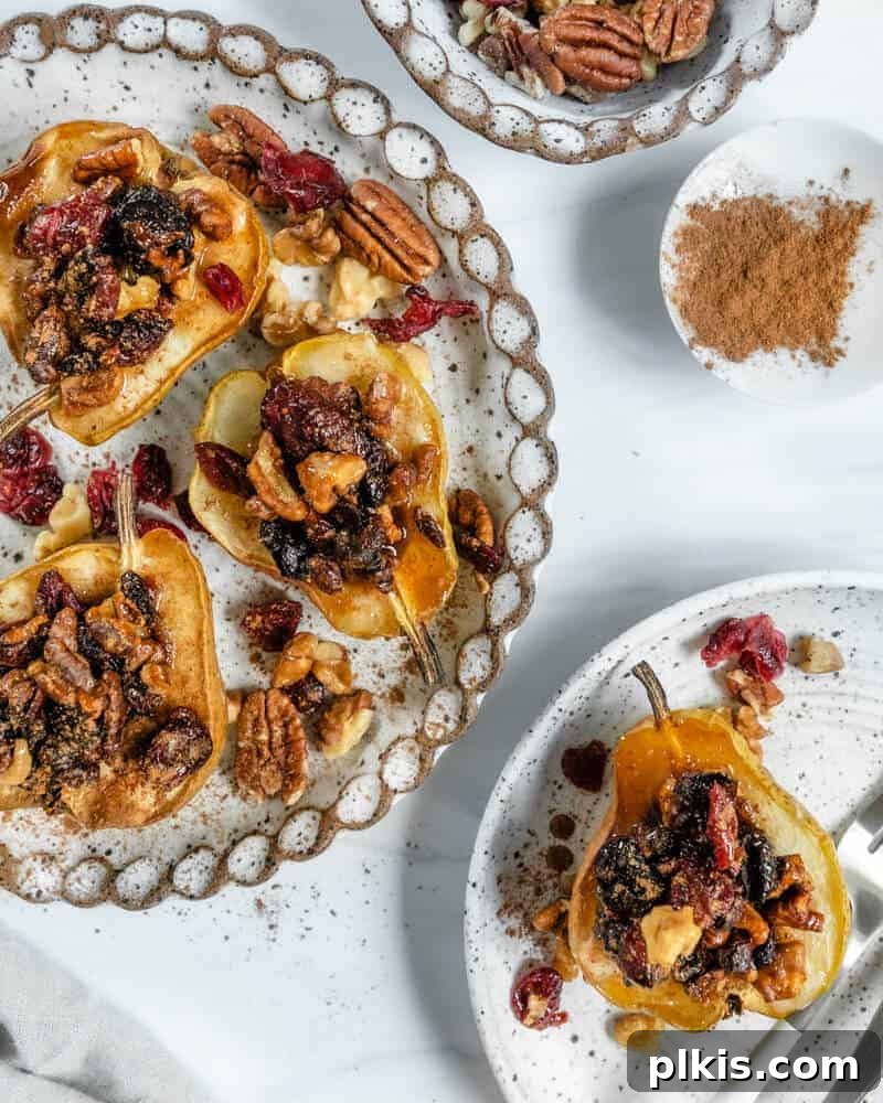 45 Mouthwatering Vegan Thanksgiving Recipes 76 Several beautifully baked pears, elegantly plated with ingredients in the background.
