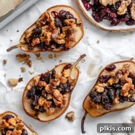 Completed Easy Baked Pears [Stuffed with Nuts and Fruit] on a white surface.