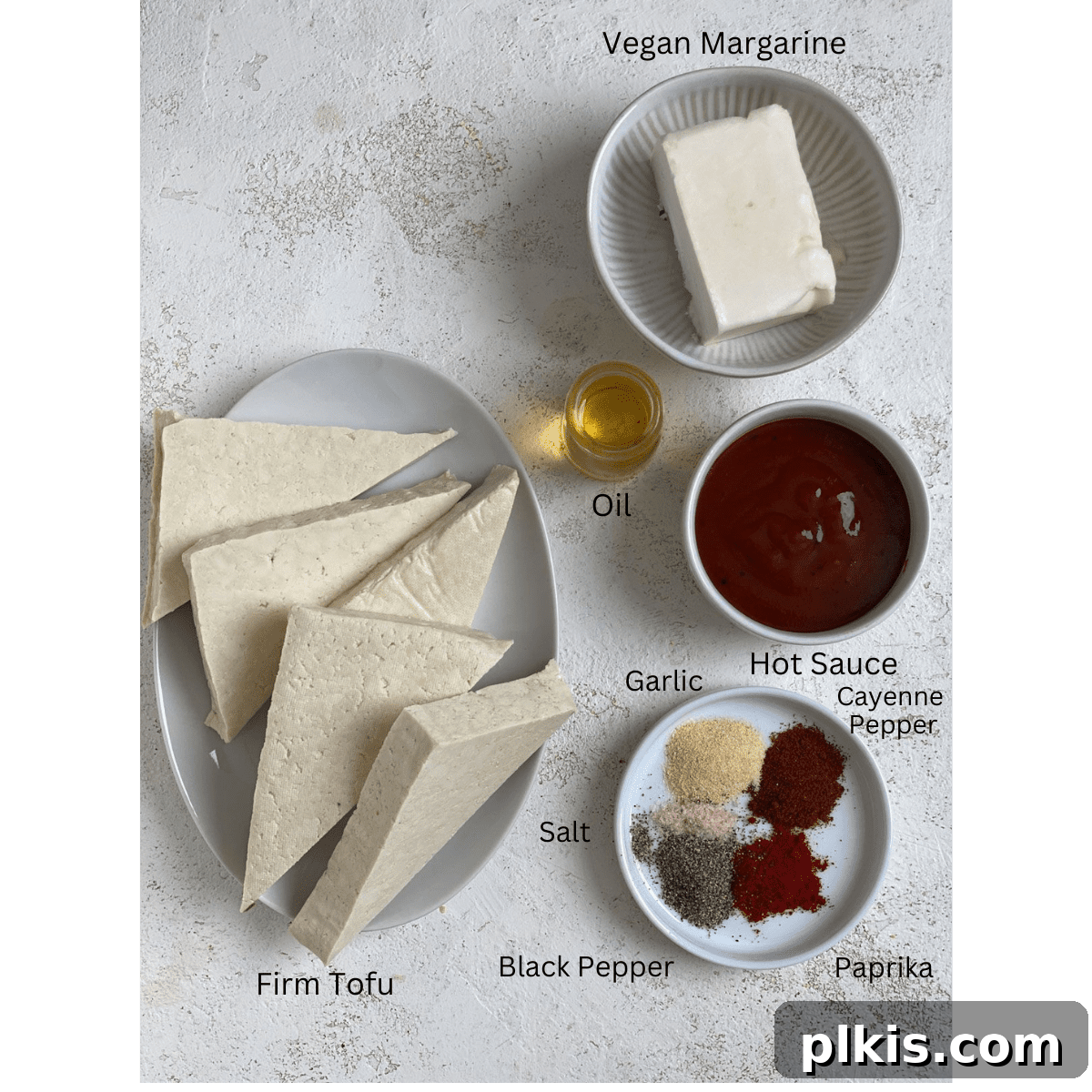 Buffalo Tofu Your Way: Easy Fried, Baked, or Air-Fried 3 Ingredients for Easy Buffalo Tofu laid out on a white surface
