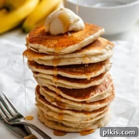 completed stack of pancakes against a white surface