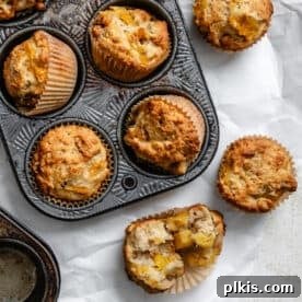 completed Easy Pineapple Muffins [Multiple Ways] in a muffin tray and on a white surface