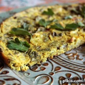 Vegan kale fritatta on a patterned plate.