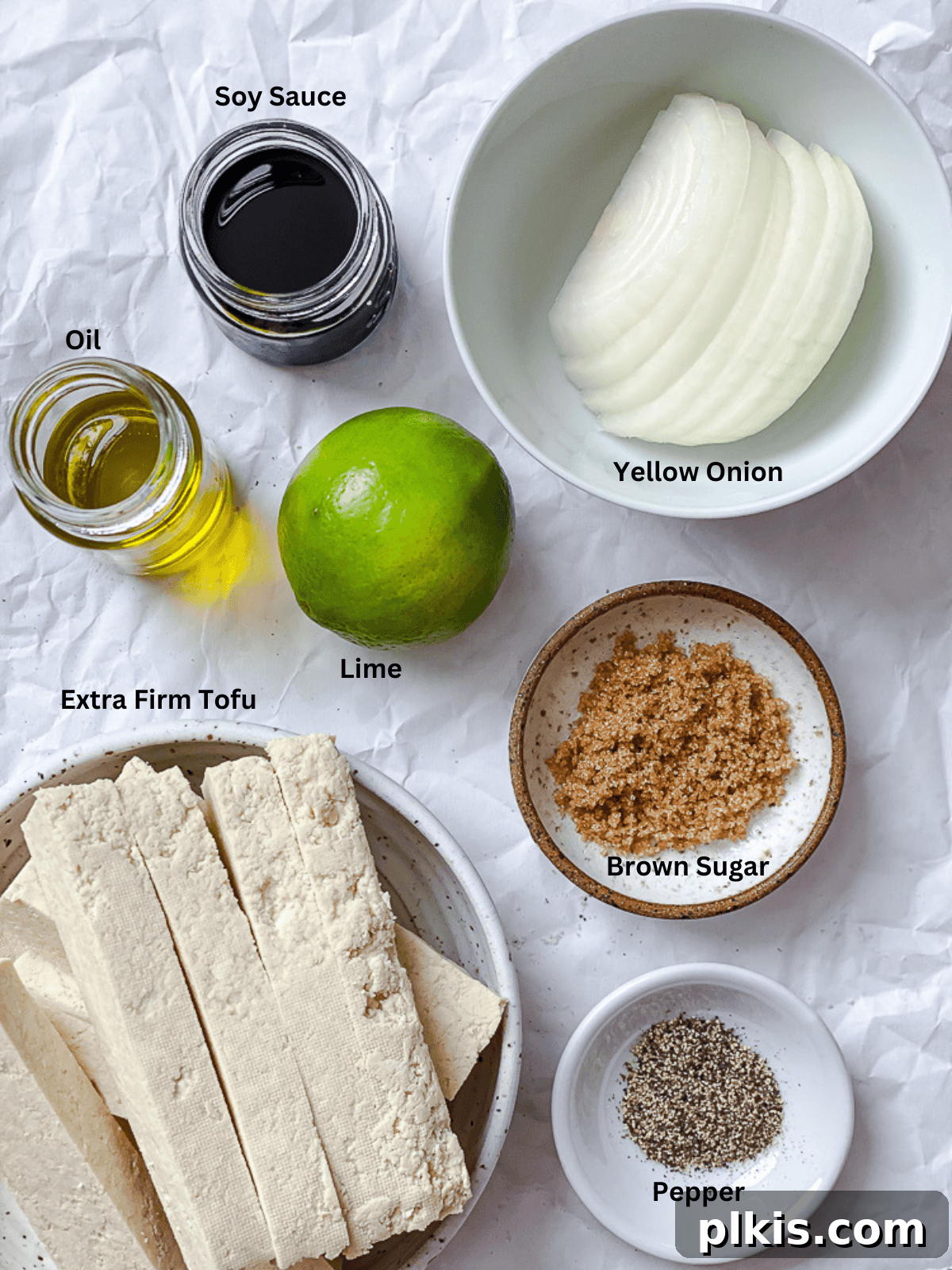 Zesty Lime Tofu Sauté 3 Ingredients for Sautéed Lime Soy Tofu measured out on a white surface.