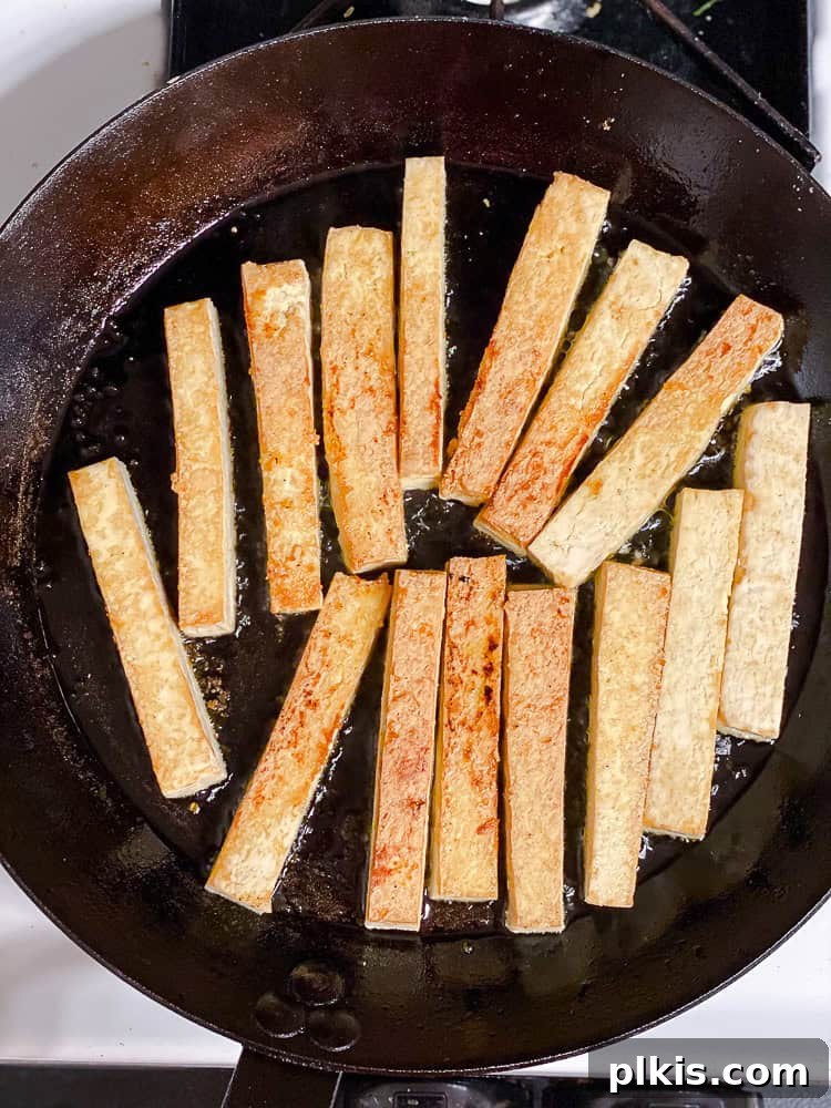 Zesty Lime Tofu Sauté 5 Process shot showing tofu cooking in pan.