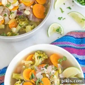 A bowl of Mexican vegetable soup next to the cooking pot.